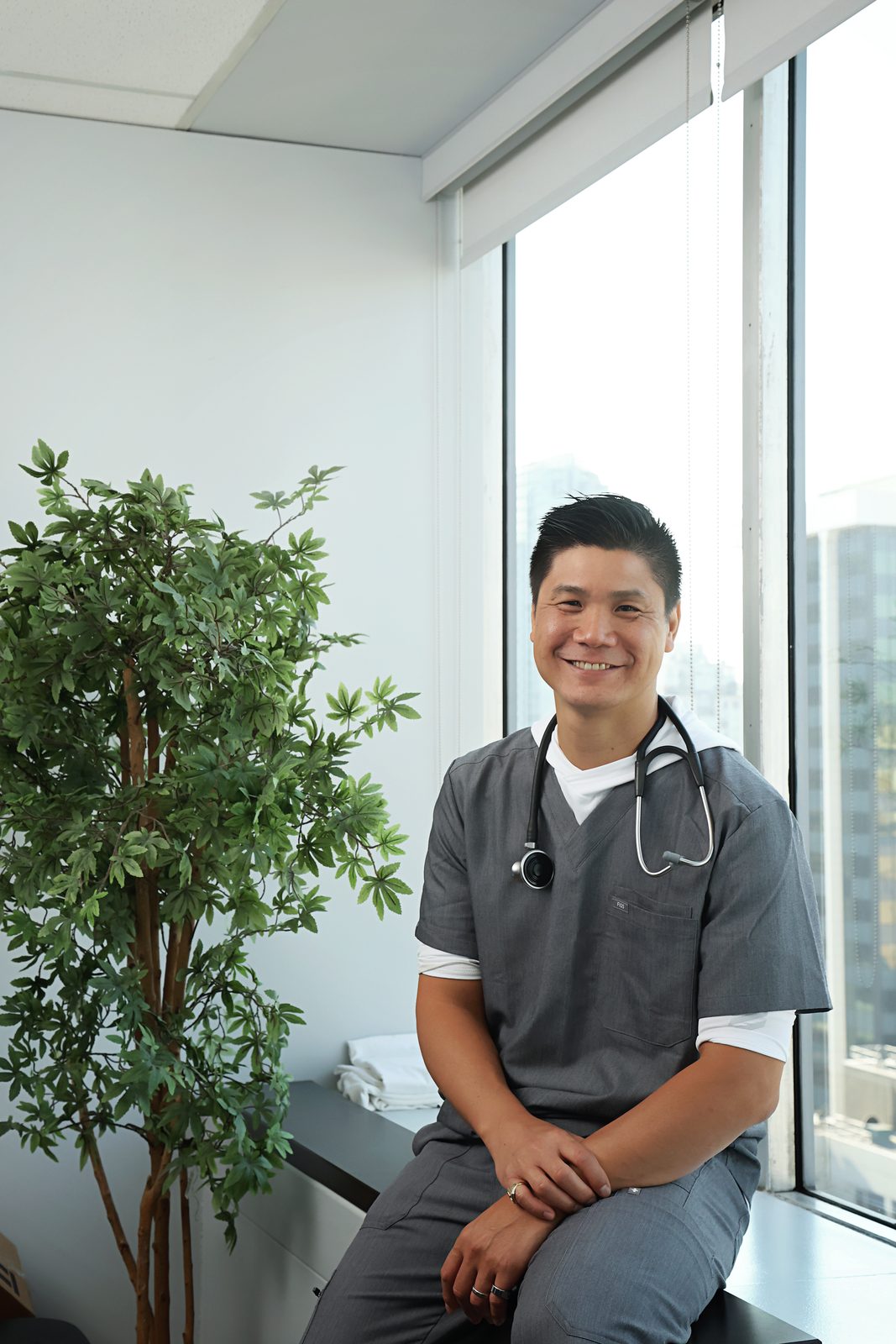 Dr. Marr by window with plant